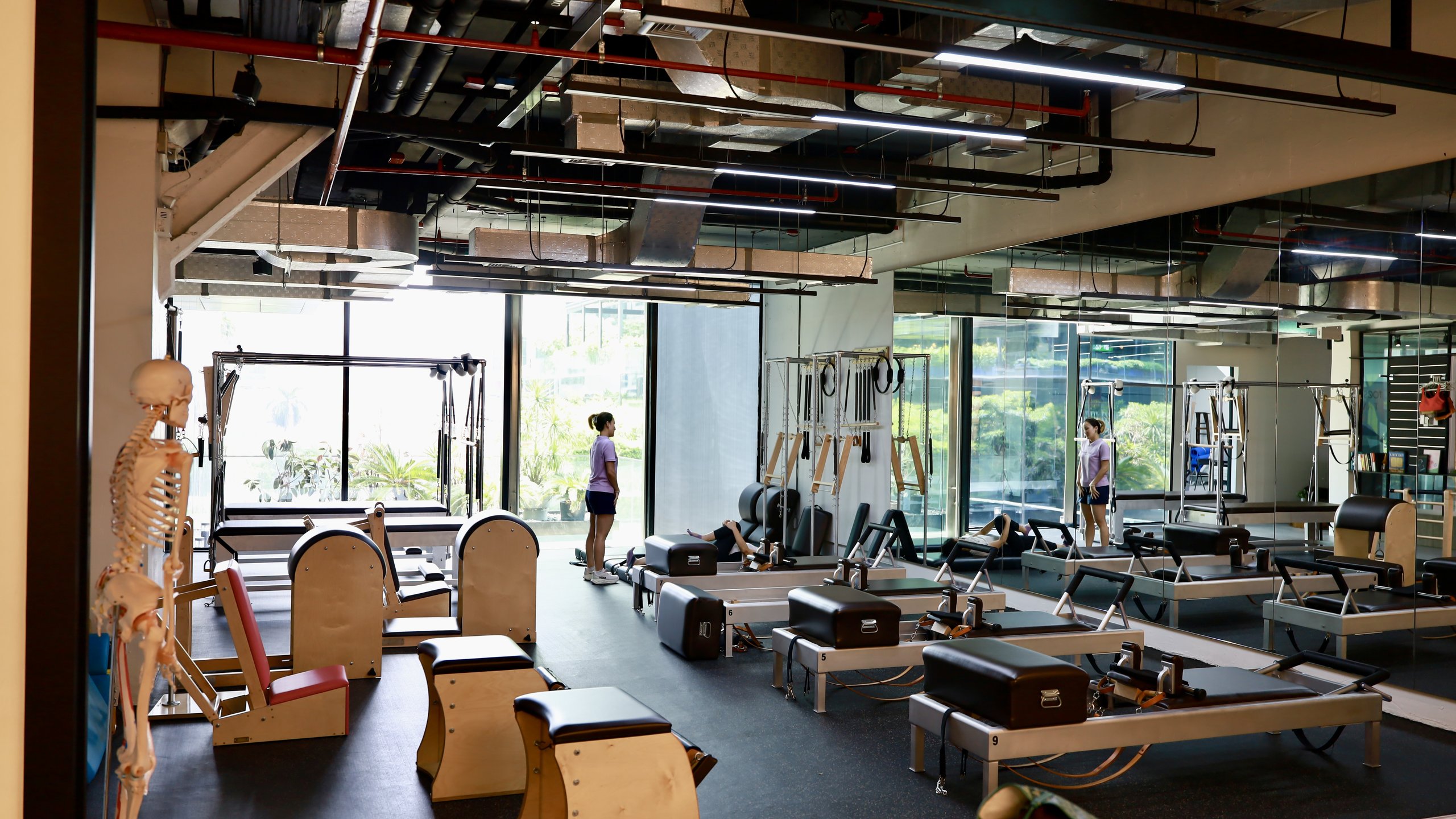 RM58 Pilates studio — dark cinematic interior with warm light on Gratz apparatus