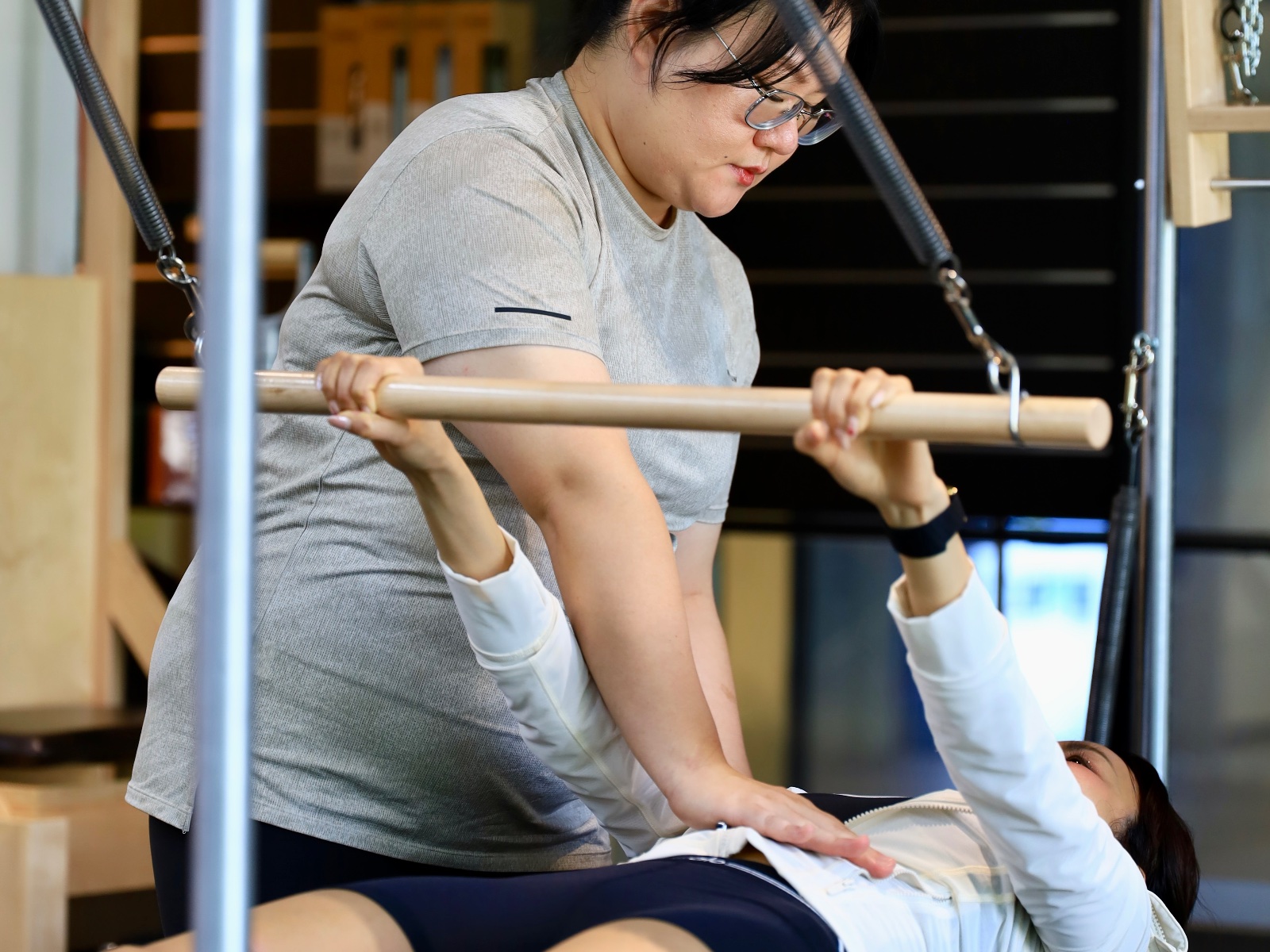 Kru Aeoy with hands-on adjustment during a movement